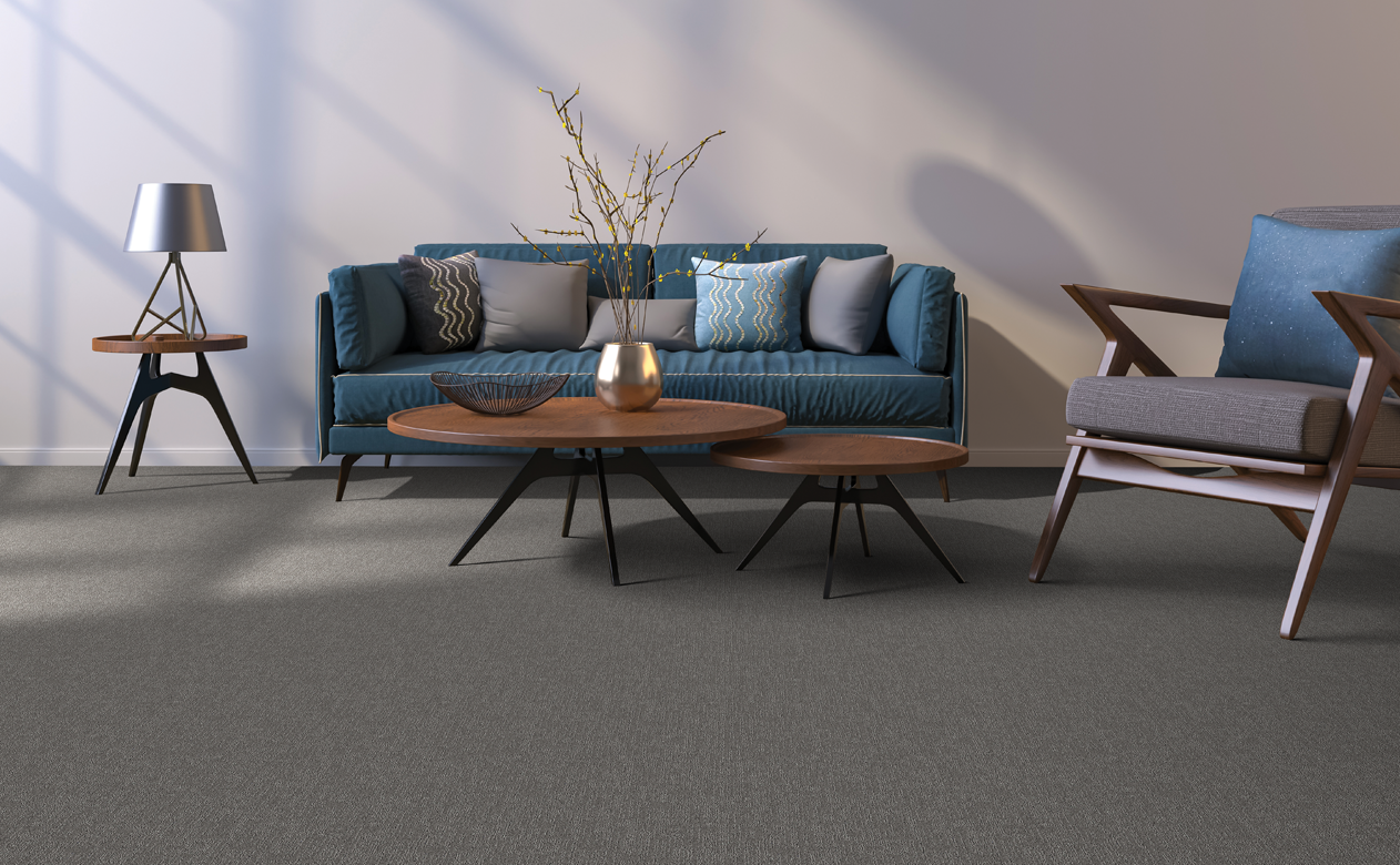 Gray carpet in living room with a blue sofa